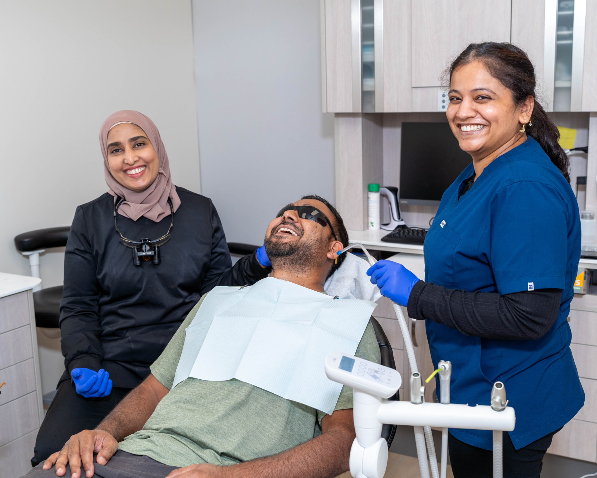 SmileHaven Dentistry treatment room with a patient and two team members